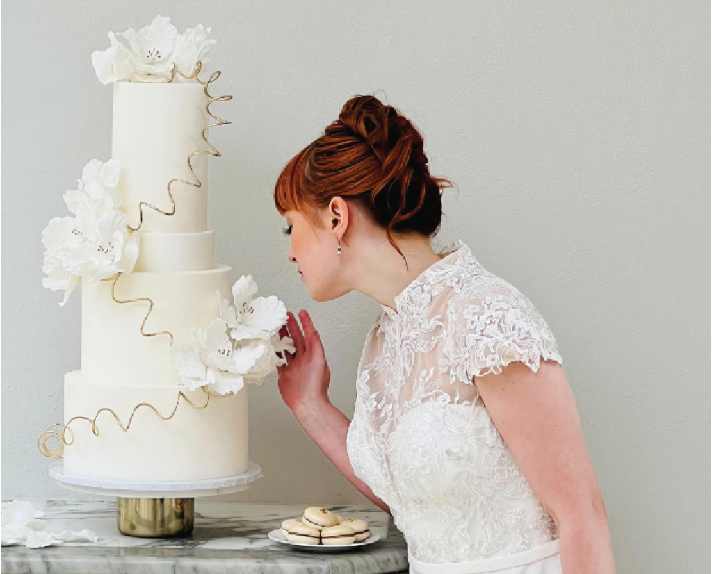 Exceptional Wedding Cakes Loughborough - lady viewing her beautiful wedding cake made by Sugar Creations by Dimple