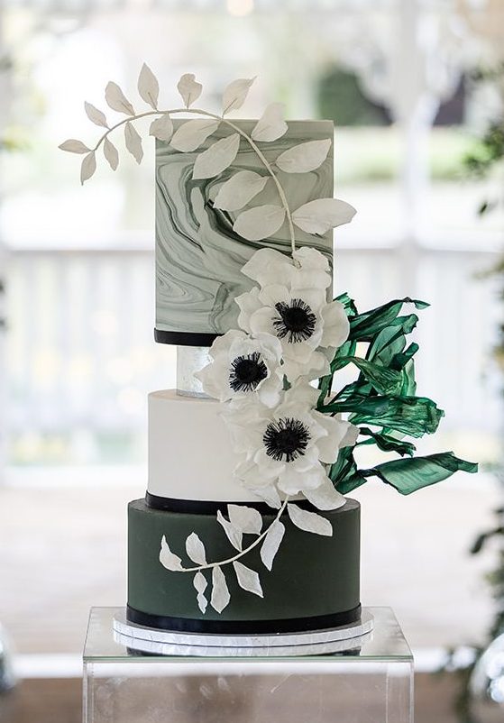 Modern white and green wedding cake with silver details and handmade wafer flowers — elegant luxury wedding cake design inspiration.