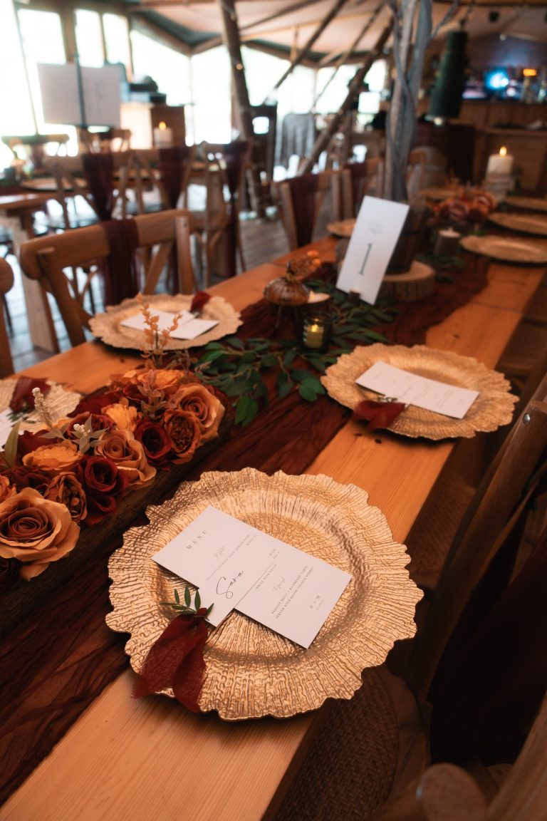 Beautifully set wedding tables decorated with warm autumnal and winter tones, ready to welcome guests at a Leicestershire wedding in the East Midlands.