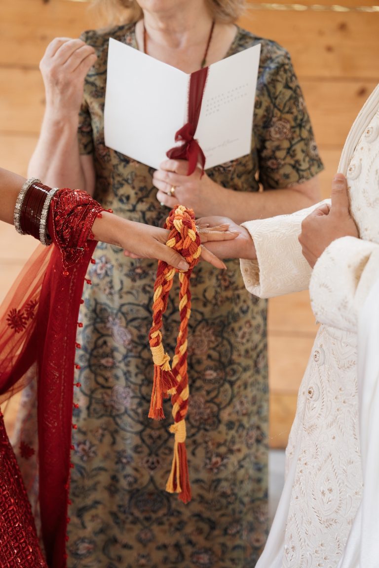 A celebrant leading a heartfelt rope ceremony as two newlyweds join hands, symbolizing unity and love at a Leicestershire wedding in the East Midlands.