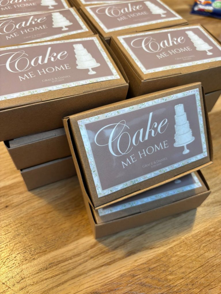 Custom cake boxes designed by Grace using the original wedding cake illustration created by Sugar Creations by Dimple, used to gift slices of their luxury wedding cake to guests.